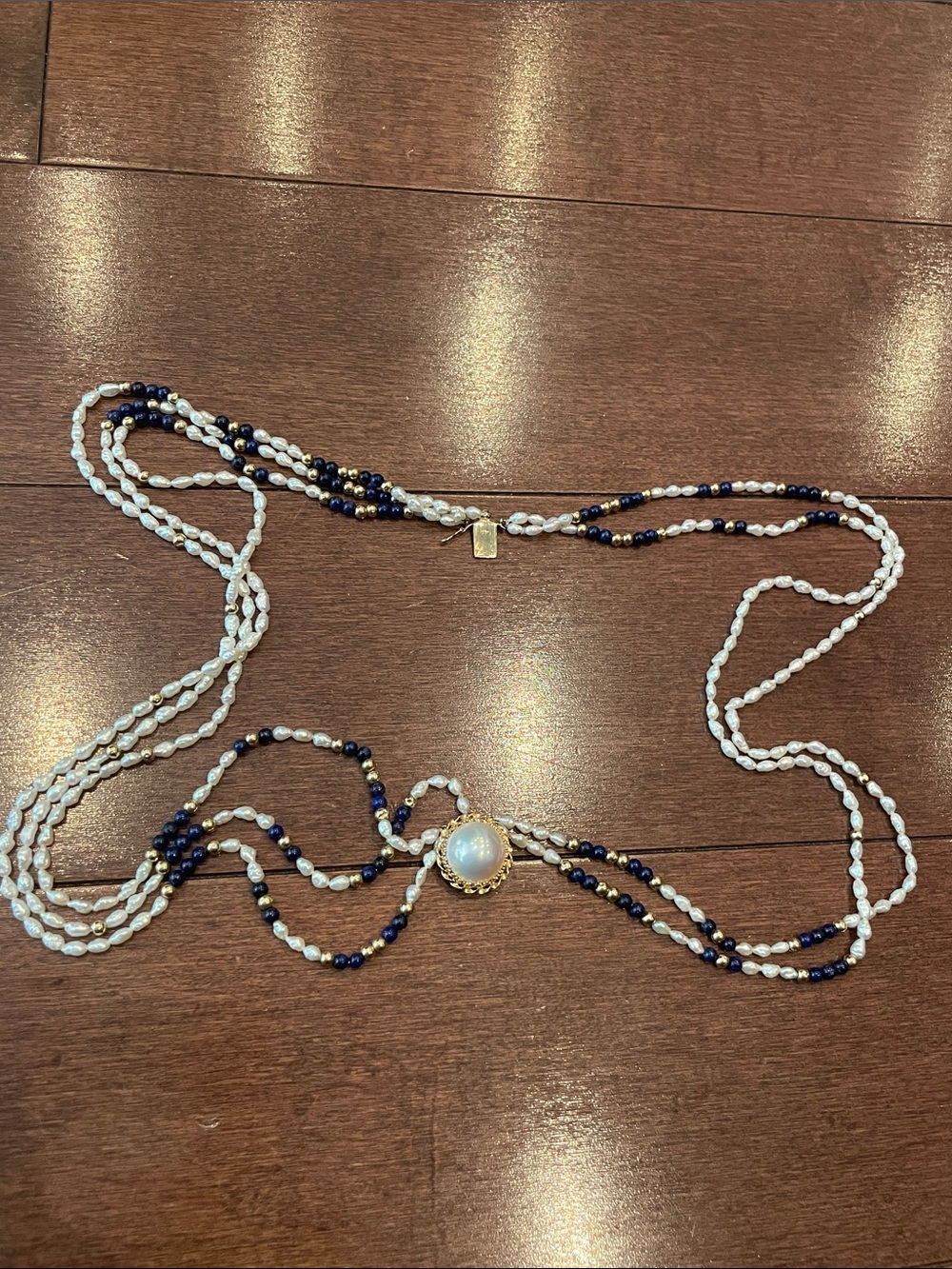 14 K gold clasp 5 Strand White Pearl and Navy Bead Necklace with Gold Accent